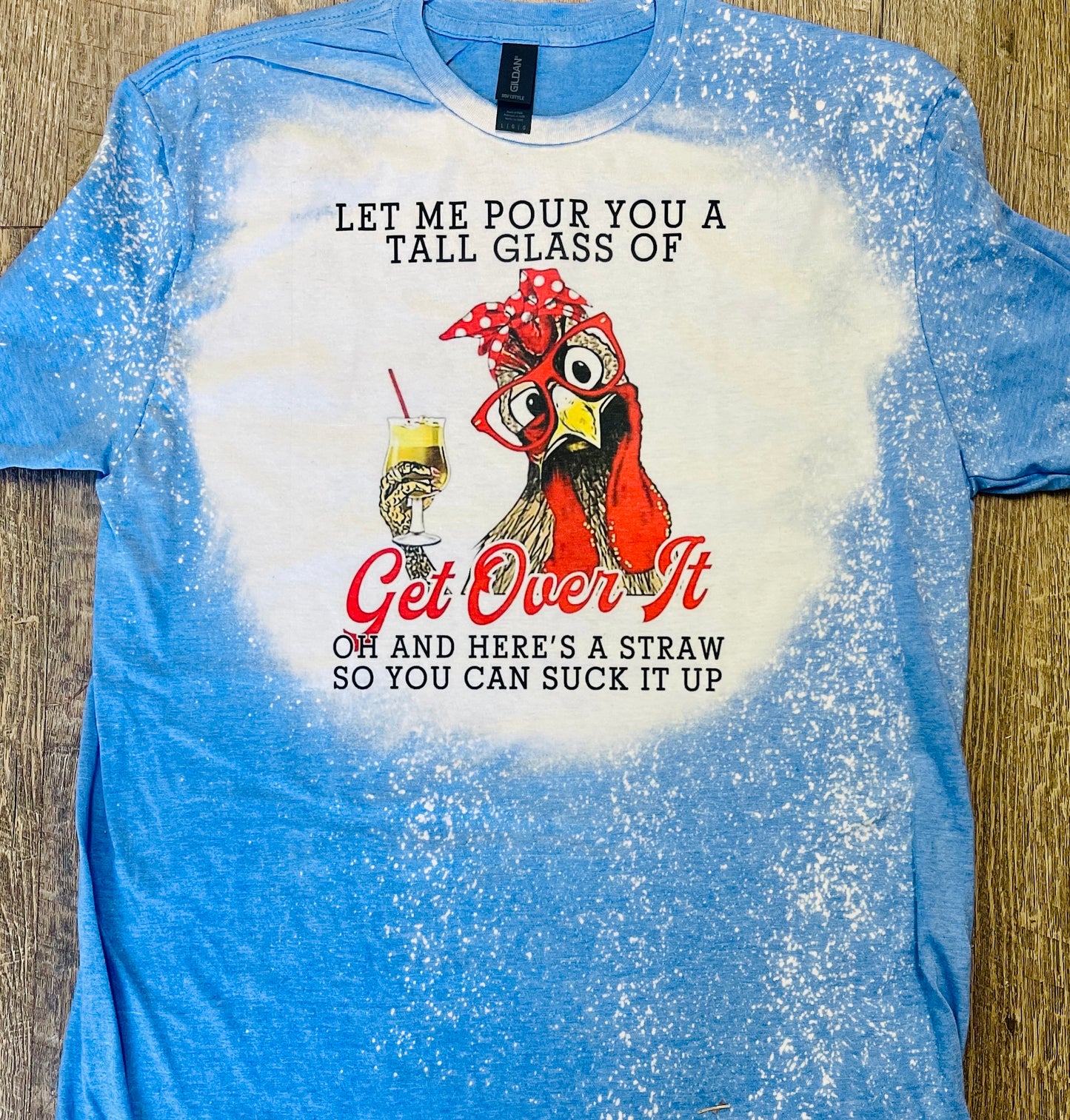 Product details  Custom sublimated tee that reads “Let me pour you a tall glass of GET OVER IT, oh and here's a straw so you can suck it up" Pressed on a soft style Gildan shirt Short sleeve  Fits true to size Contact us about a custom color shirt.   *Colors may vary slightly due to monitor resolution and lighting* Southern Bliss Boutique 