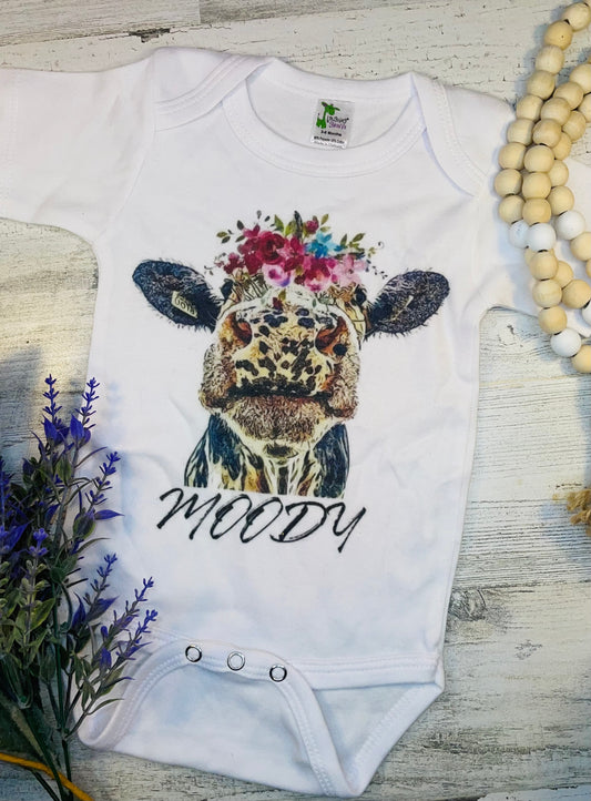 Product details  Custom sublimated  onesie that reads "Moody" Pressed on a Laughing Giraffe Short sleeve  Fits true to size Contact us about a custom color shirt.   *Colors may vary slightly due to monitor resolution and lighting* Southern Bliss Boutique