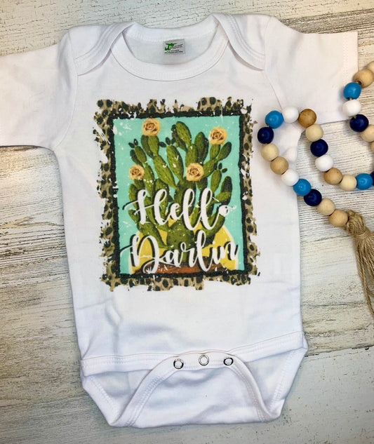 Product details  Custom sublimated  onesie that reads "Hello Darlin" Pressed on a Laughing Giraffe Short sleeve  Fits true to size Contact us about a custom color shirt.   *Colors may vary slightly due to monitor resolution and lighting* Southern Bliss Boutique