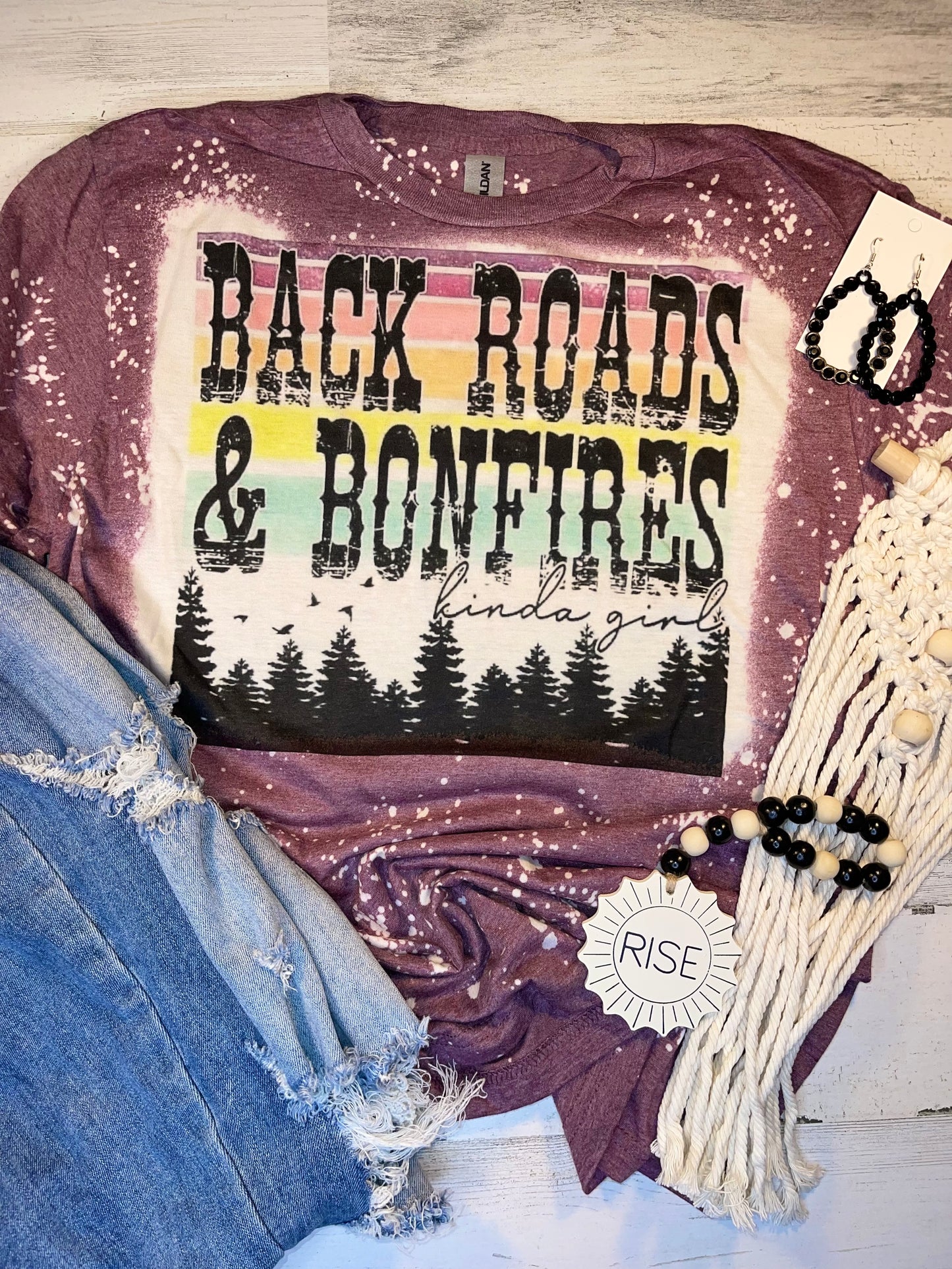 Product details  Custom sublimated tee that reads “Back Roads and Boom Fires Kind of Girl" Pressed on a soft style Gildan shirt Short sleeve  Fits true to size Contact us about a custom color shirt.  Southern Bliss Boutique